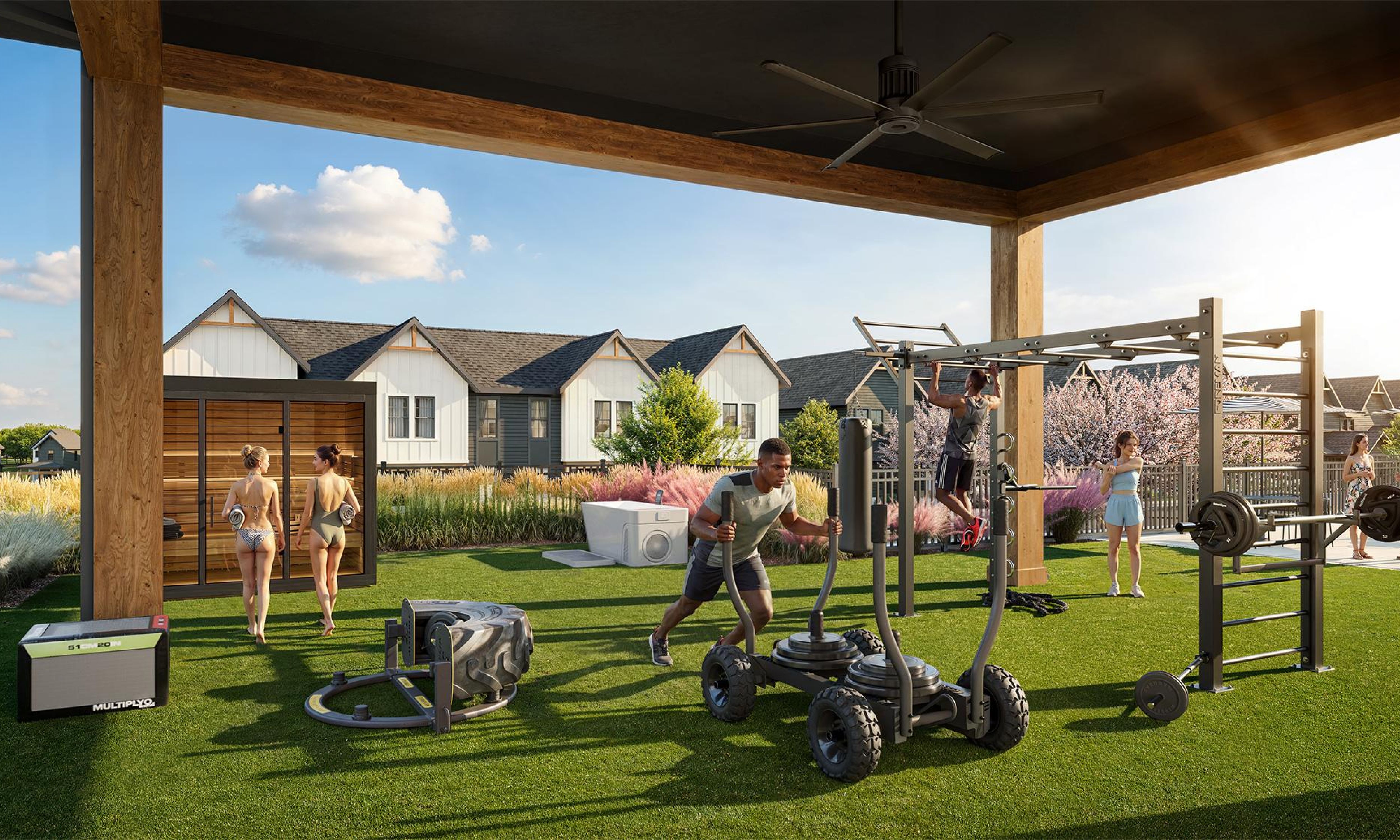 Chandelier Student Living Apartments People exercise and socialize on a covered outdoor gym area with fitness equipment, near houses and landscaped greenery on a sunny day.