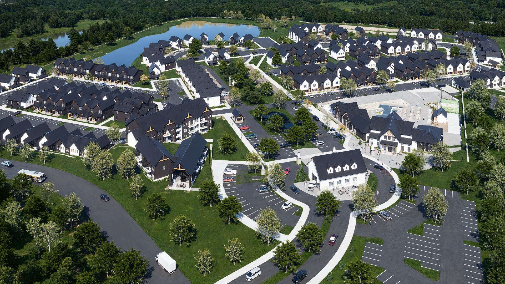 aerial view of black roof townhomes and pond at chandelier in oxford ms