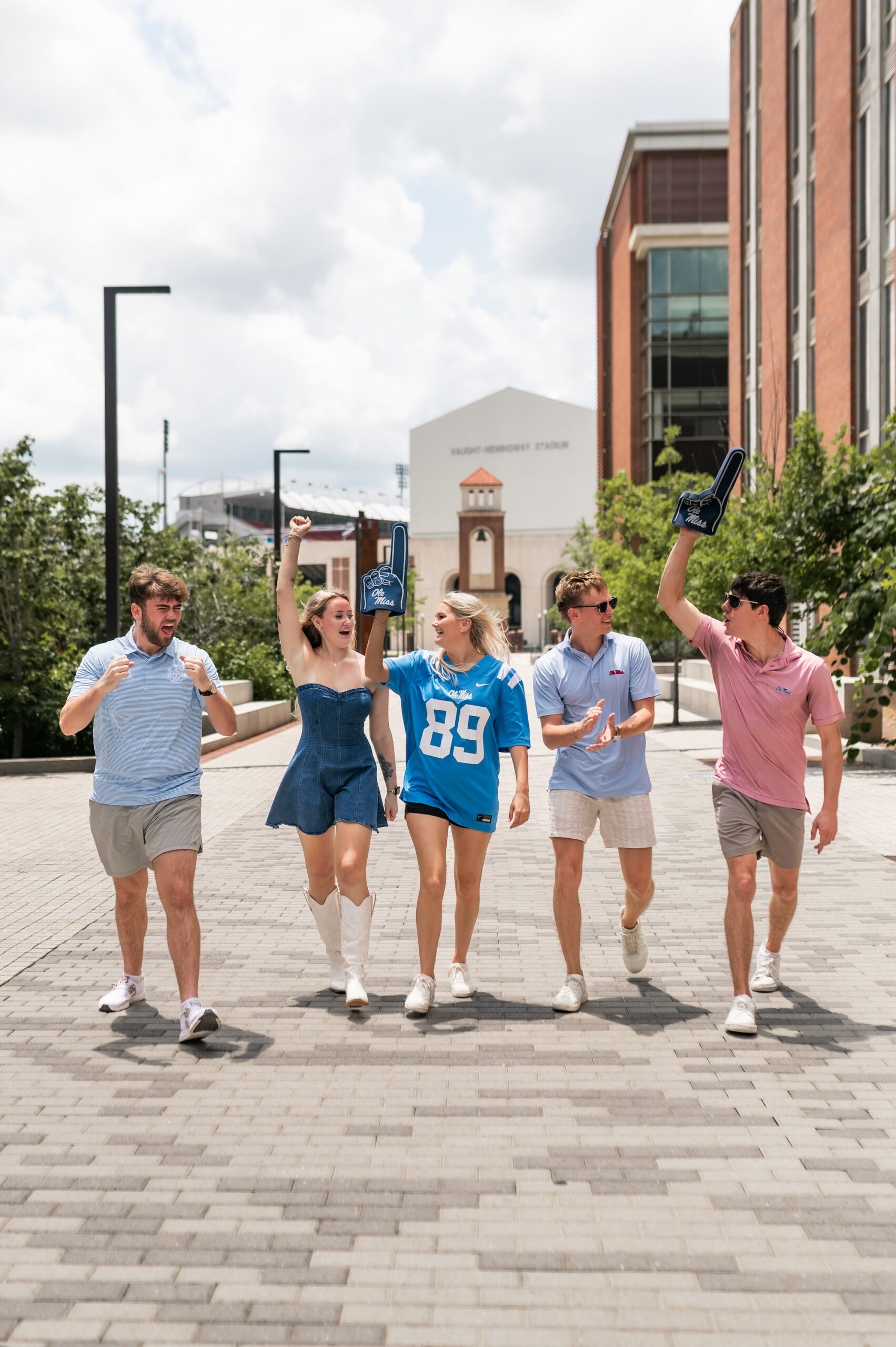 cheering college students on campus walkway scaled