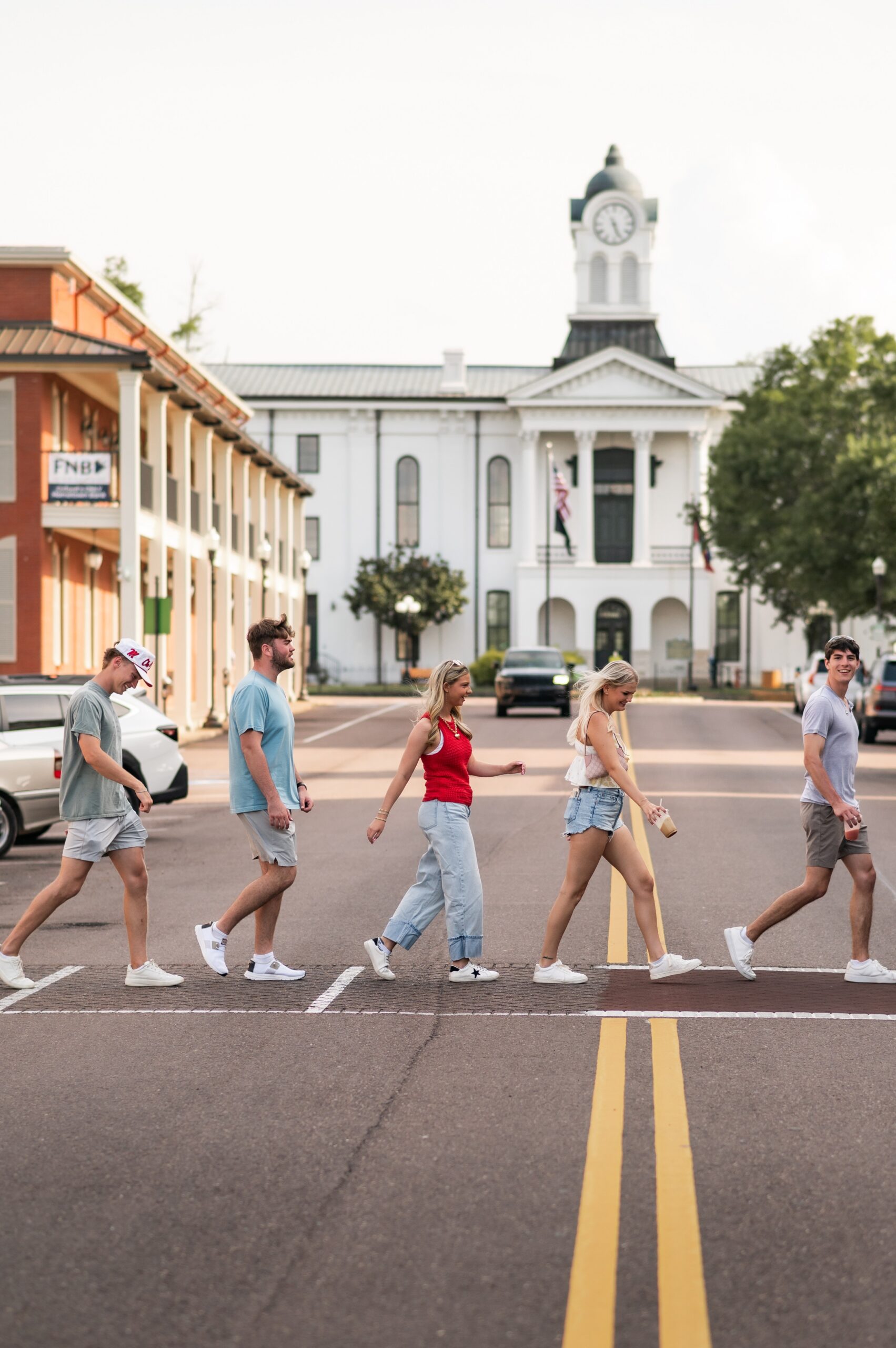 college friends crossing downtown street scaled