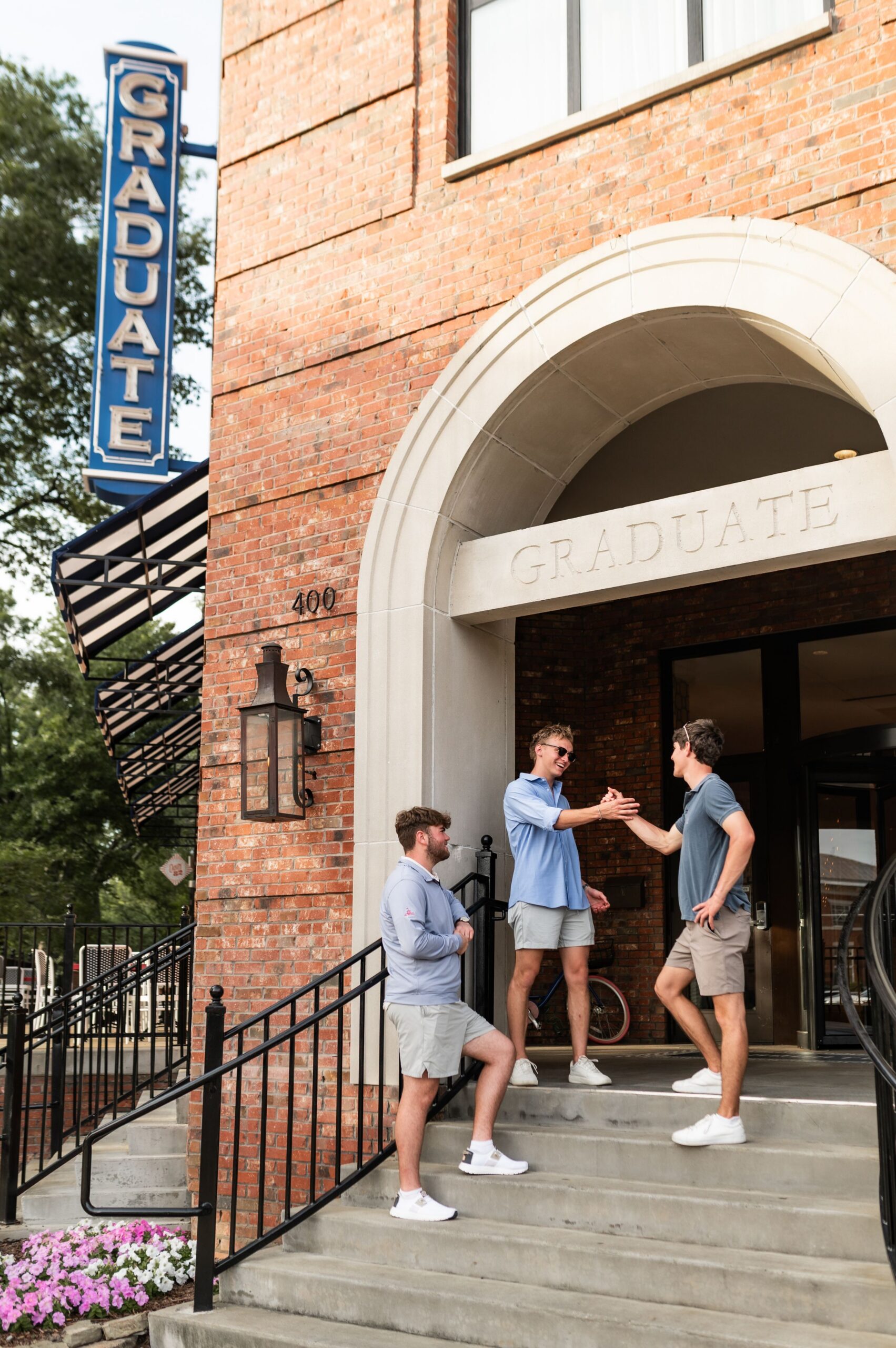 college students outside graduate hotel scaled