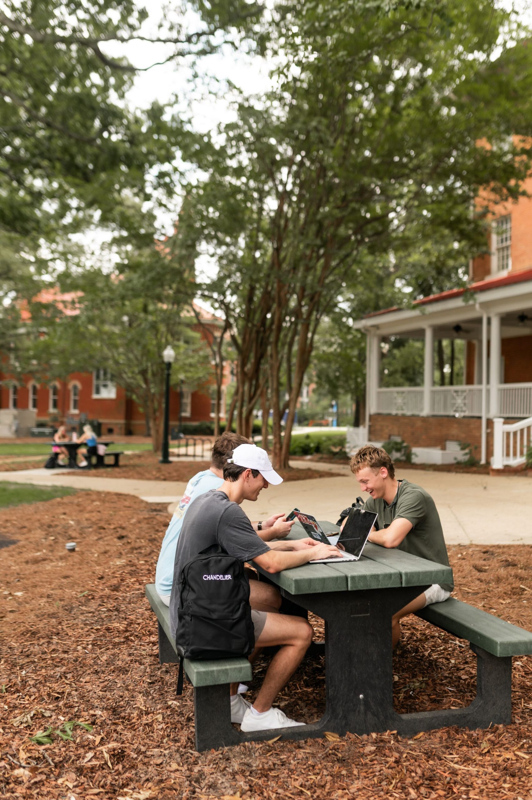 college students socializing over laptops scaled