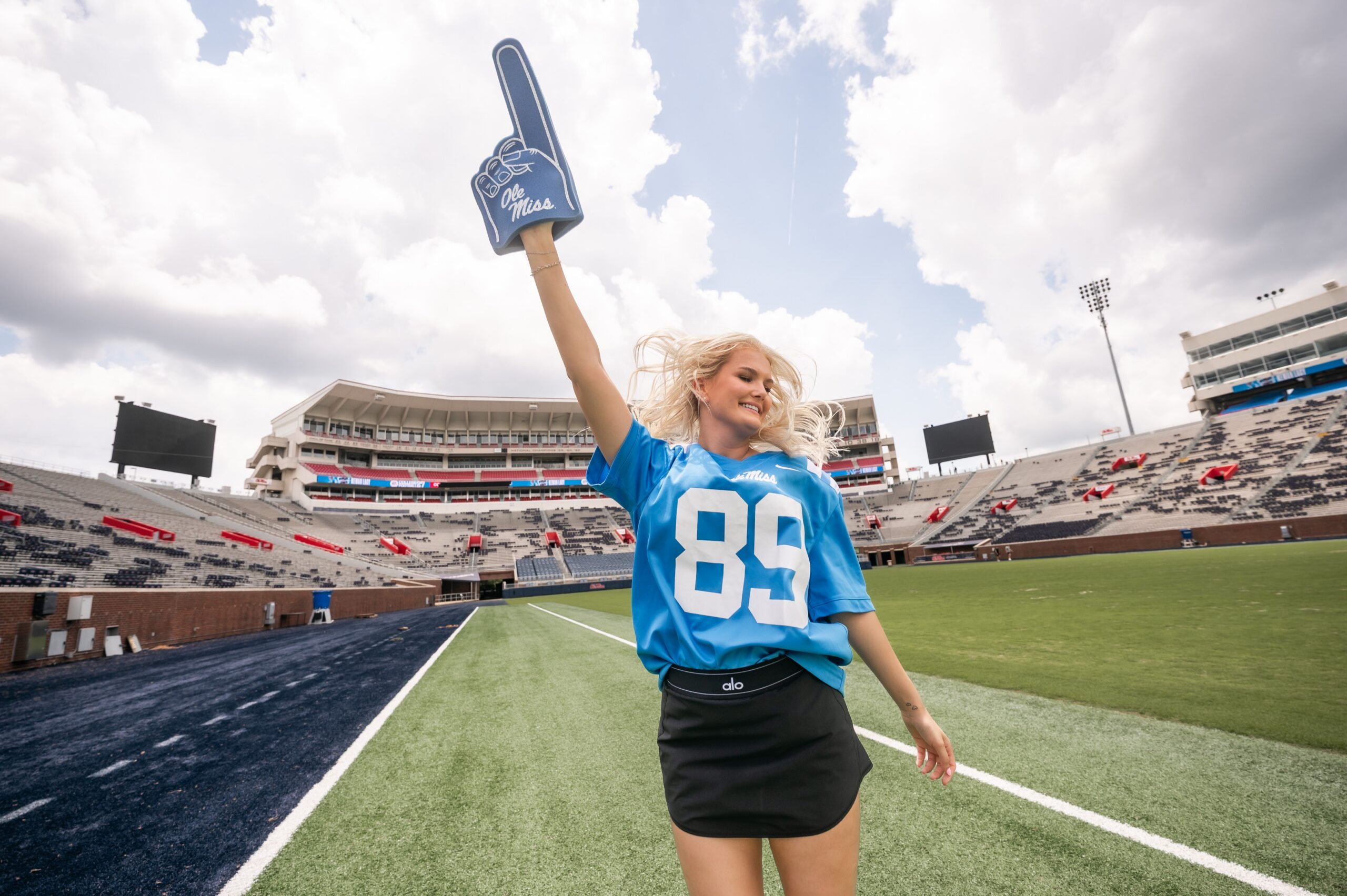 ole miss fan celebrating on football field scaled