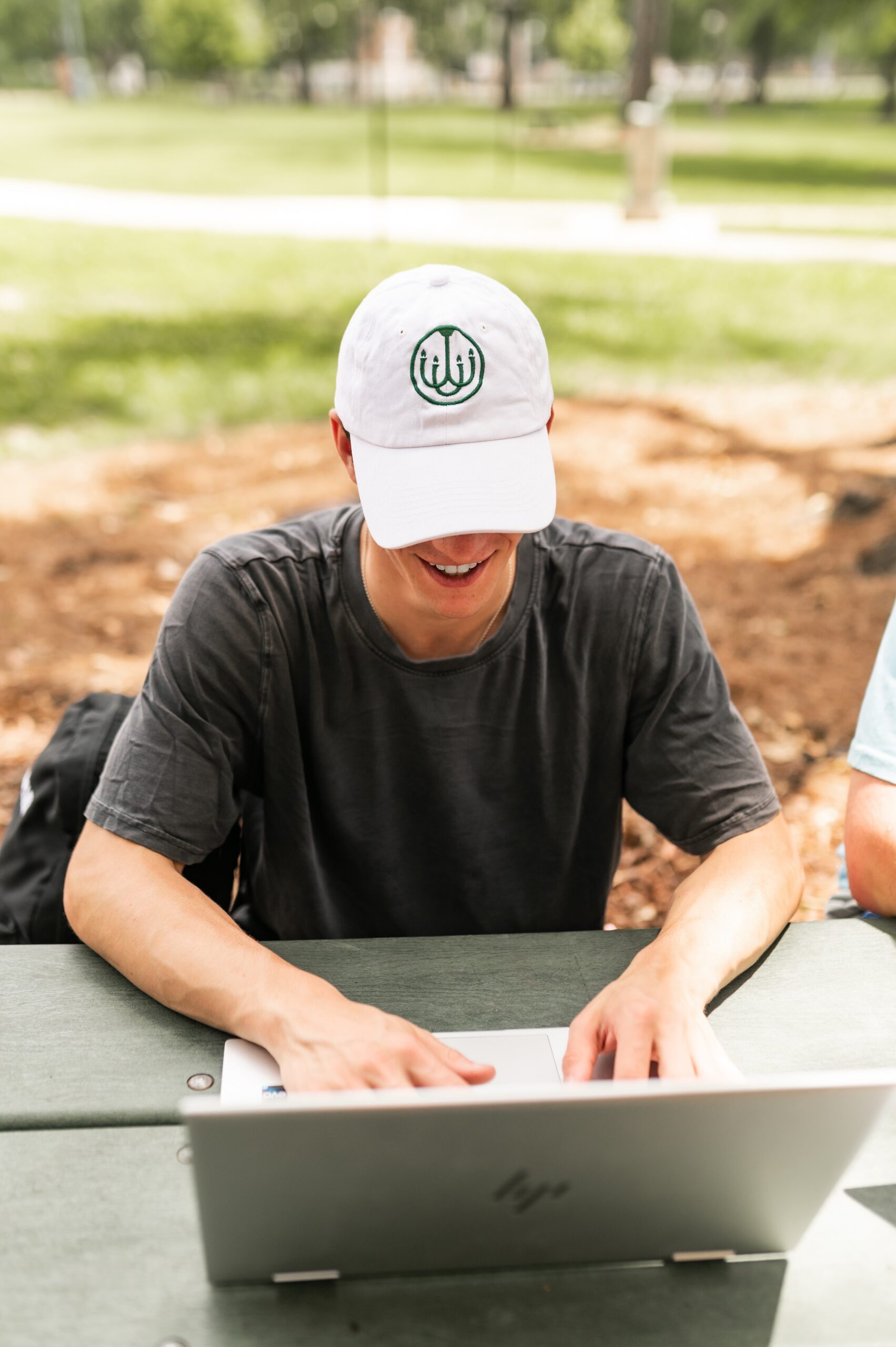 student working on laptop outdoors scaled