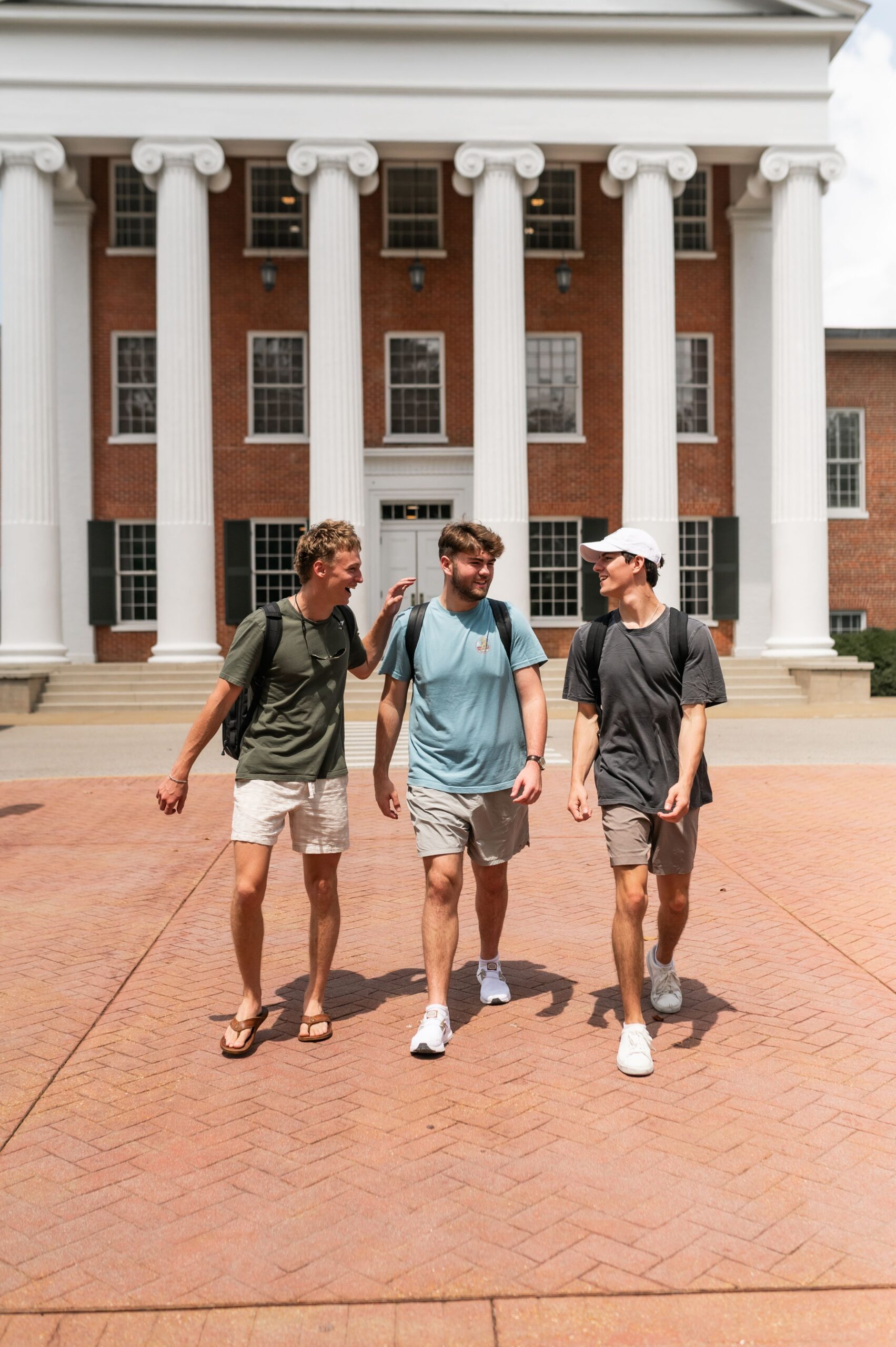 undergraduate friends walking past columns scaled