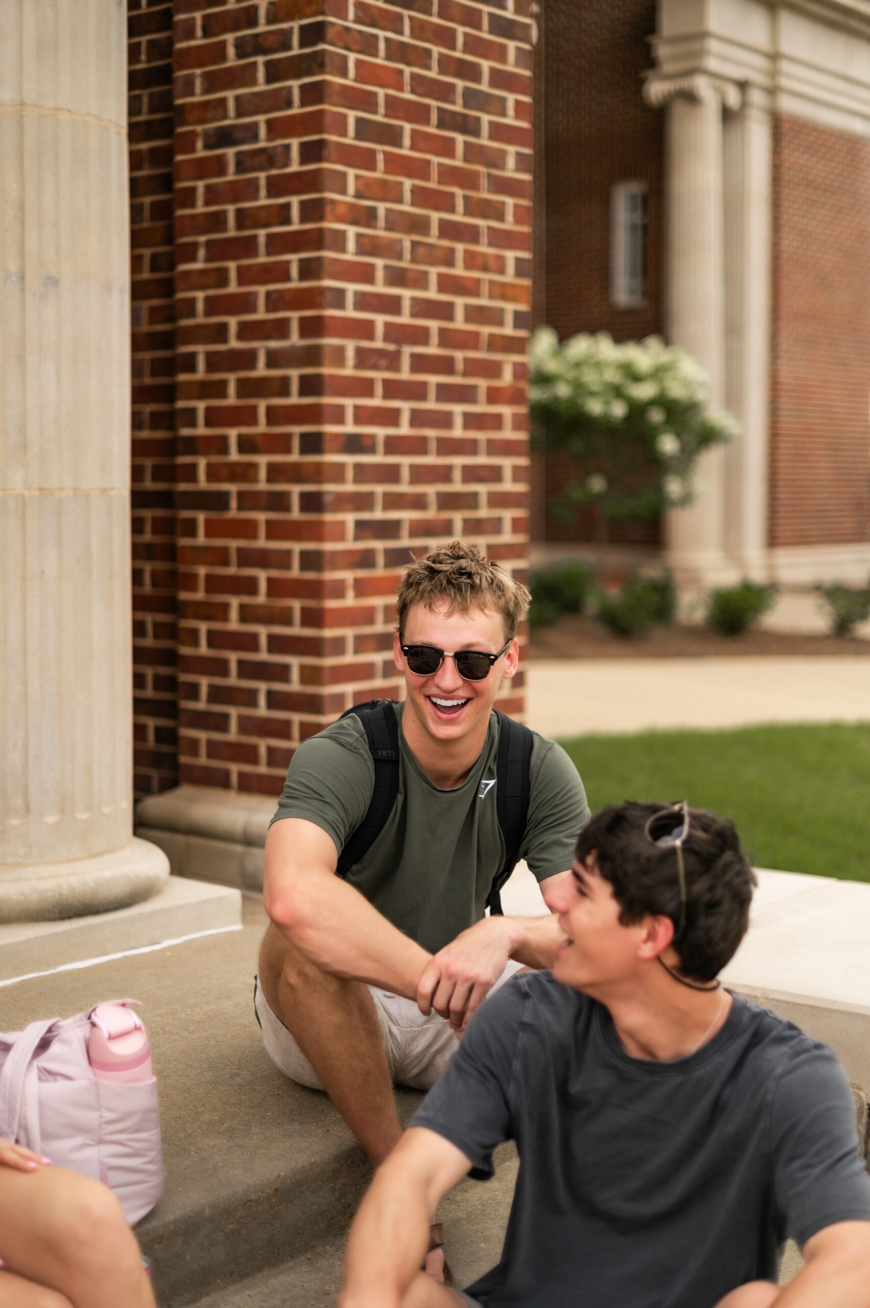 undergraduates laughing on building stairs scaled