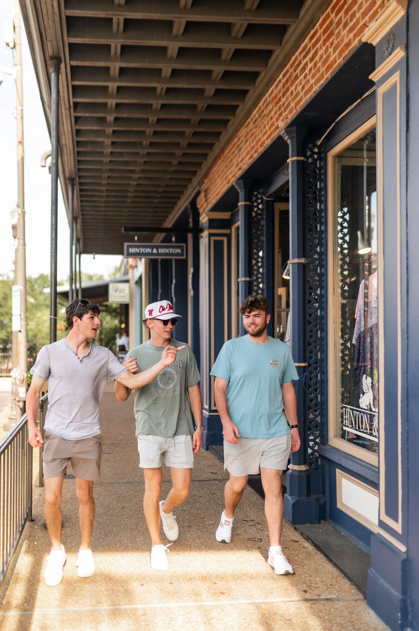 undergraduates walking past downtown storefronts scaled