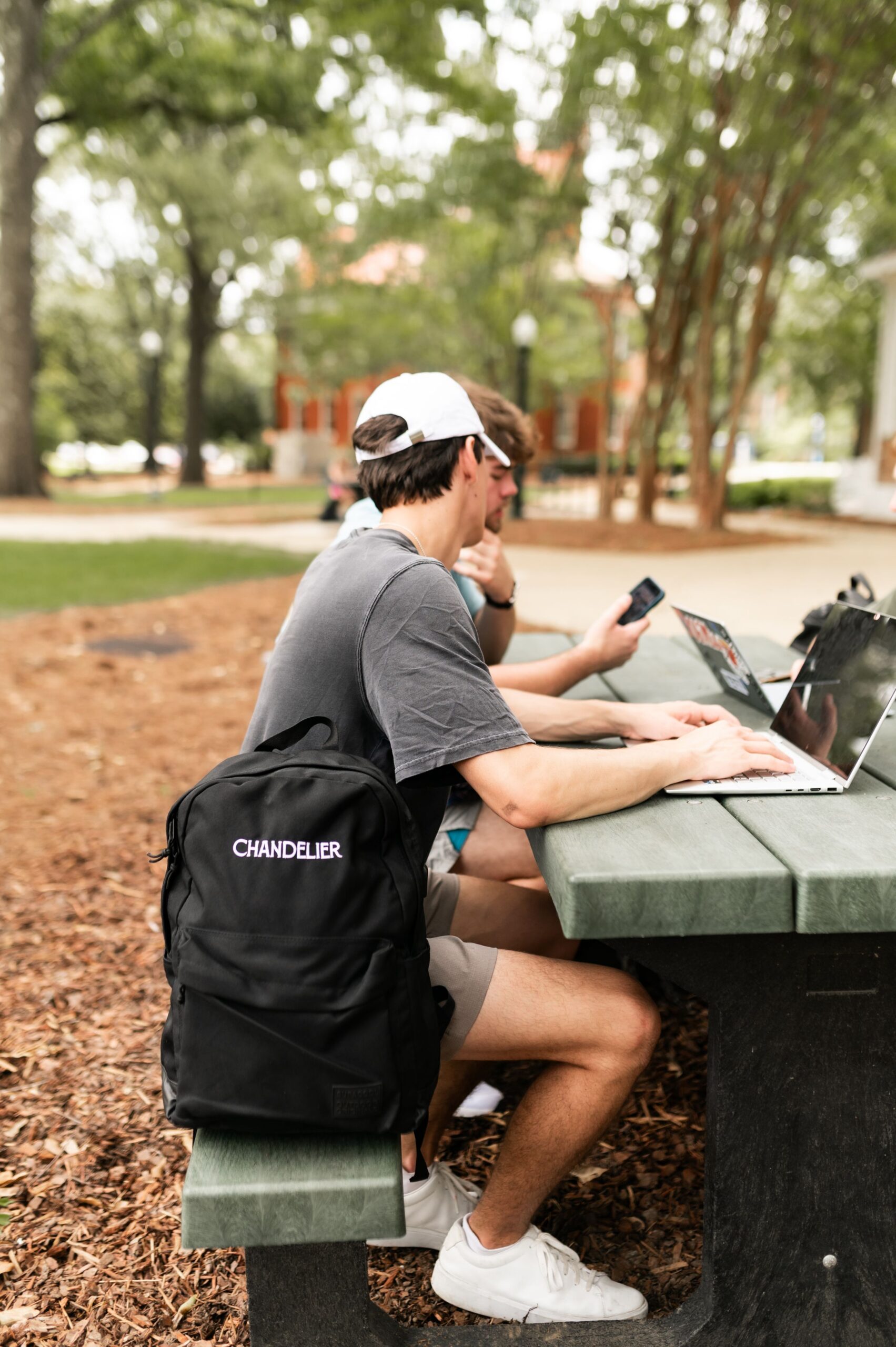 undergraduates working at outdoor picnic table scaled
