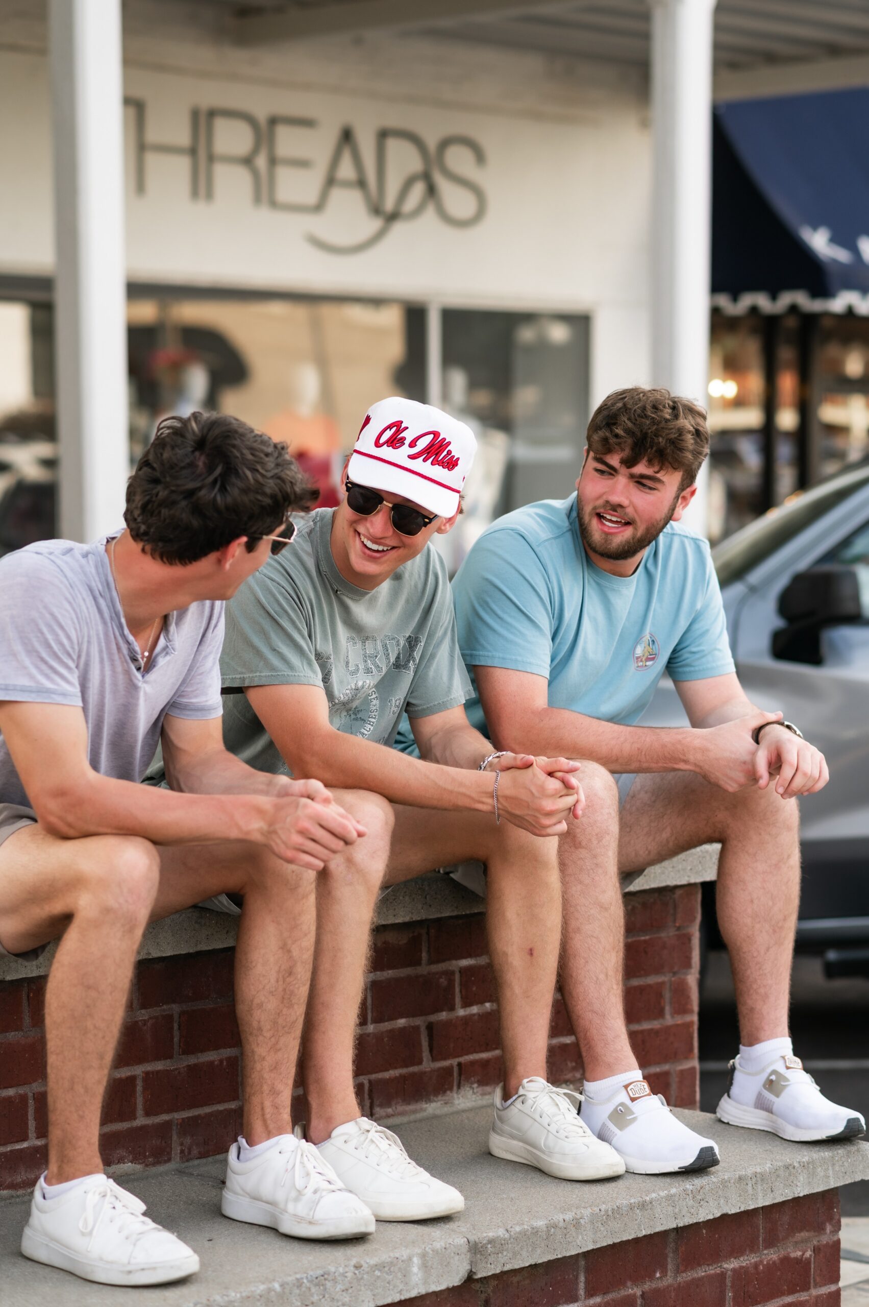 university friends socializing outside storefront scaled