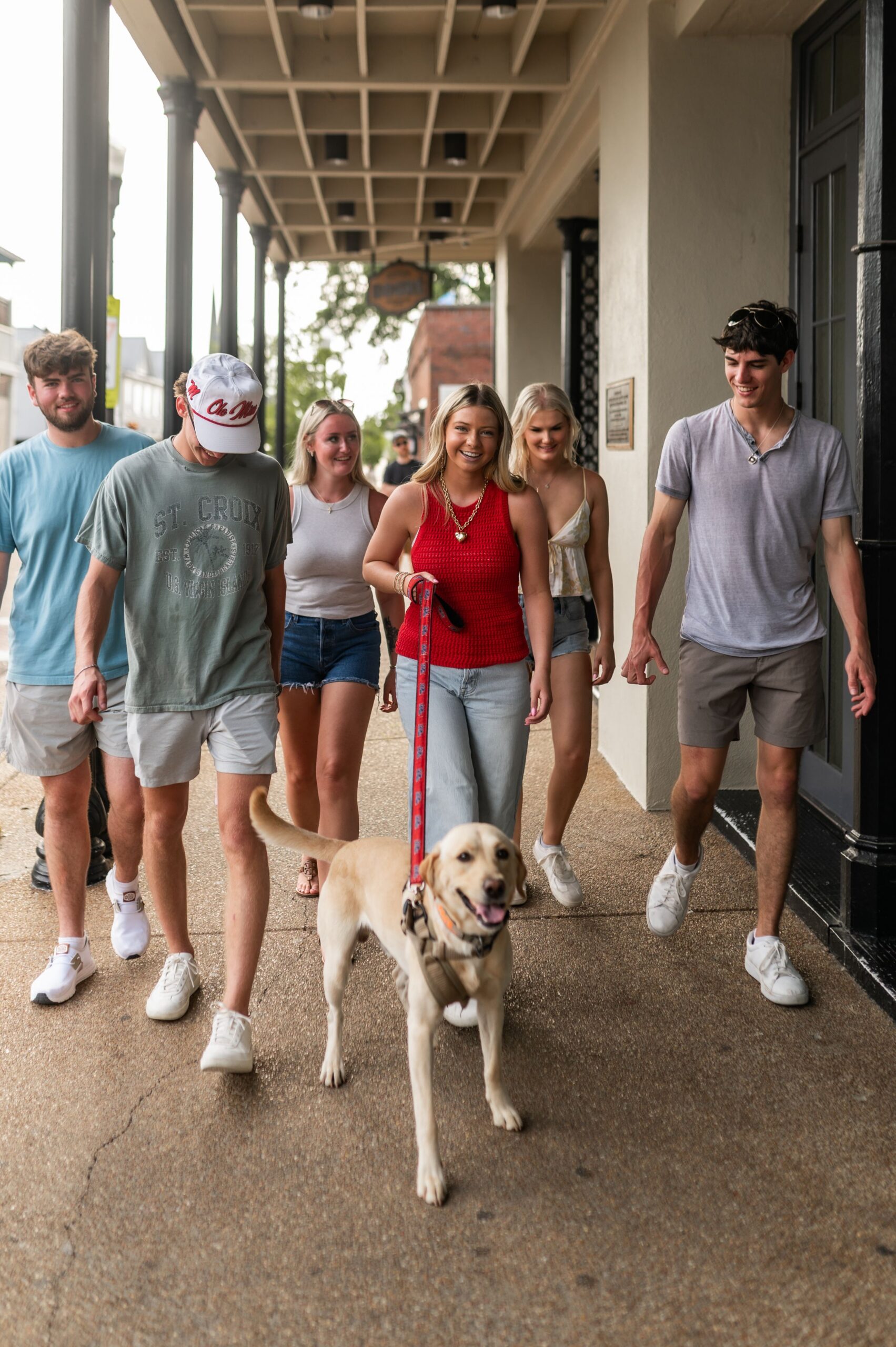 university students walking dog downtown scaled